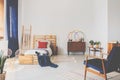 Copy space on the white wall of oldschool teenager bedroom with wooden furniture and dark blue accents