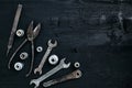 Copy space of working tools on a black wooden surface. Nippers, wrench keys, pliers, screwdriver. Top view.