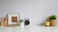 Copy space workspace with photo frame, coffee, plant decoration, pencil on office desk Royalty Free Stock Photo