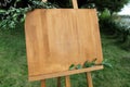 Wooden easel with a board. On the board written white paint - Welcome. Royalty Free Stock Photo