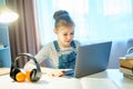 Student girl studying something using computer and headphones at home Royalty Free Stock Photo