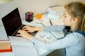 Teenage girl studying something using computer and headphones at home Royalty Free Stock Photo