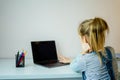 Teenage girl studying something using computer and headphones at home Royalty Free Stock Photo