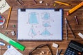 Copybook with geometry pictures and student material on wooden table. Royalty Free Stock Photo