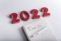 Copybook with TIME TO inscription and red numbers 2022 on white background. Goals and dreams plans for 2022