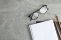 Copybooks, glasses and pencil on grey table Royalty Free Stock Photo