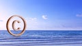 Copyright concept, author rights and patented intellectual property, Copyright Symbol Protection Sign on sea beach background. Royalty Free Stock Photo