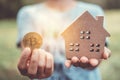 Copyspace model of a little house and a symbol of cryptocurrency that woman holds it background. Deam life have own house property Royalty Free Stock Photo