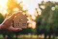 Copyspace model of a little house that woman holds it background Royalty Free Stock Photo