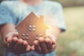 Copyspace model of a little house that woman holds it background Royalty Free Stock Photo