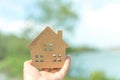 Copyspace model of a little house that woman holds it background Royalty Free Stock Photo