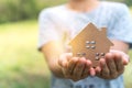 Copyspace model of a little house that woman holds it background Royalty Free Stock Photo