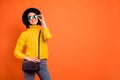 Copyspace photo of independent woman traveling alone while isolated with orange background