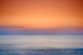 Copyspace seascape of an orange sunset on the west coast of Jutland in Loekken, Denmark. Sun setting on the horizon on