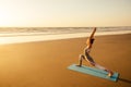 Copyspace woman doing yoga performing asanas and enjoying life at sunset on the beach sea copy space