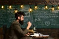 Copywriter blogger and journalist. Hipster man with beard and glasses type on typewriter creating content, writing