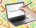 Copywriter profession. Woman writing word on laptop screen with pencil against yellow background with letters, closeup