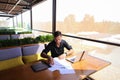 Copywriter typing text on laptop at cafe table.