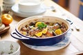 coq au vin in a traditional french ceramic dish