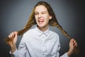 Coquettish girl. Closeup Portrait handsome teen smiling isolated on grey