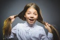 Coquettish girl. Closeup Portrait handsome teen smiling isolated on grey