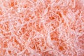 Coral color shredded paper - gift box filler background. Royalty Free Stock Photo