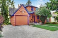 Coral exterior American house with blue trim with garage.