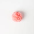 Coral fluffy fur ball on white background
