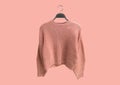 Coral oversize knit sweater on hanger Royalty Free Stock Photo