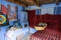 Corbi, Romania - July 2019: traditional peasants house interior well preserved with authentic carpets, clothing and personal items
