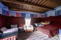 Corbi, Romania - July 2019: traditional peasants house interior well preserved with authentic carpets, clothing and personal items