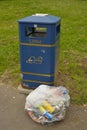 Corby, U.K., June 20, 2019 - plastic bag with trash garbage on street Royalty Free Stock Photo