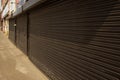 Corby, United Kingdom. April 18, 2019. Street view of roller shutter doors, shops display