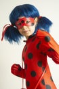 Corby, United Kingdom. March 12, 2019 - little girl in Ladybug Myraculous cosplay costume. Superhero ladybug with blue twig,