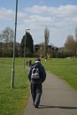 Corby, United Kingdom. March 13, 2019 - Old man walking in the autumn park. Copy space