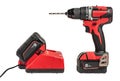 cordless drill with a drill on a white isolated background, side view. A set of a cordless drill and a charger that Royalty Free Stock Photo