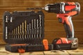Cordless drill driver in red with rubberized handle in profile with drill bits set Royalty Free Stock Photo