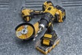 Cordless drill with a metal drill bit, angle grinder and impact wrench on a steel surface. Concept of construction, workshop tools Royalty Free Stock Photo