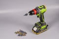 Cordless drill and various drill bits on a gray surface Royalty Free Stock Photo
