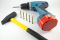 Cordless screwdriver, screws and a hammer Royalty Free Stock Photo