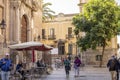 Cordoba, Andalusia, Spain - November 5, 2021: View of a cozy square near a church, people resting in a cafe in the old