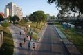 Group of men jogging in evening in residential city area. Male runners group in the park.