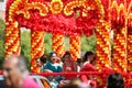 CORDOBA,SPAIN - 2 May. 2022: Battle of the flowers, Women dressed in traditional flamenco dress on cart throwing flowers