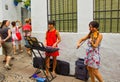 Cordoba, Spain - September 02, 2015: two young girls playing piano and violin as Street performer musician in city center main Royalty Free Stock Photo