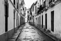 Streets of old city in Andalusia. Quiet empty street in Cordoba, Spain. Black and white Royalty Free Stock Photo