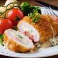 Cordon bleu stuffed with ham, cheese and vegetables on a plate
