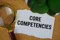 Core Competencies text written on paper with magnifying glass Royalty Free Stock Photo
