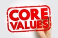 CORE VALUES presented in a strong stamp graphic with a hand and marker behind the text, representing fundamental beliefs, Royalty Free Stock Photo