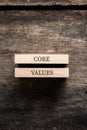 Core values sign written on two stacked wooden pegs