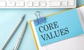 CORE VALUES text on sticker on the blue background with pen and keyboard Royalty Free Stock Photo